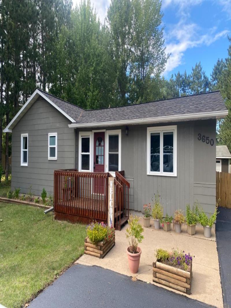 Installed Mastic Board & Batten Vertical Vinyl Siding, Thermo-Tech Full-Frame Replacement Windows, Ledgestone Versetta Accent Stone in Plover, WI